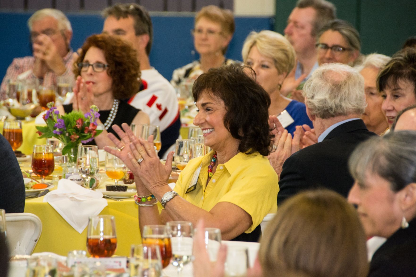 Attendees of the event clap for the presenting speaker at the Friends of Miriam Luncheon